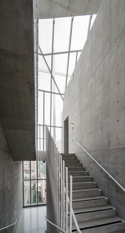 站在樓梯的最高點，我們可以親近的距離平視位於折板玻璃頂上的白色十字架;圖片提供/張瑪龍+陳玉霖聯合建築師事務所(攝影：鉉琉工作室)
