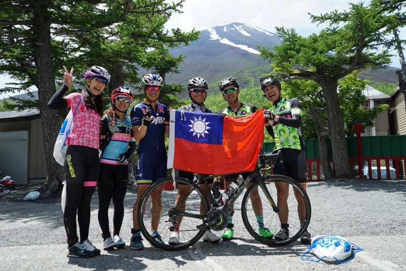 富士山攻頂與團員們開心合照之餘也不忘愛台灣喔。(小D 提供)